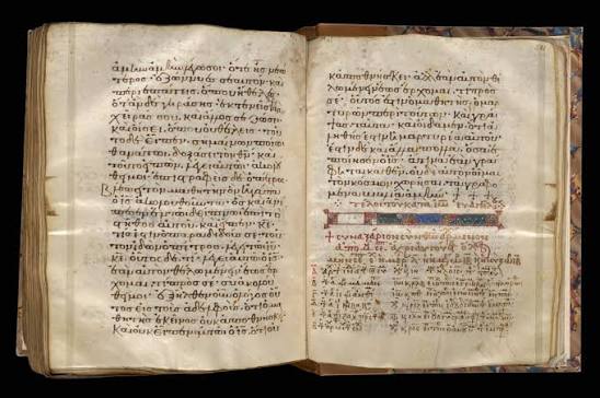 Un codice antico aperto, con testo bilingue